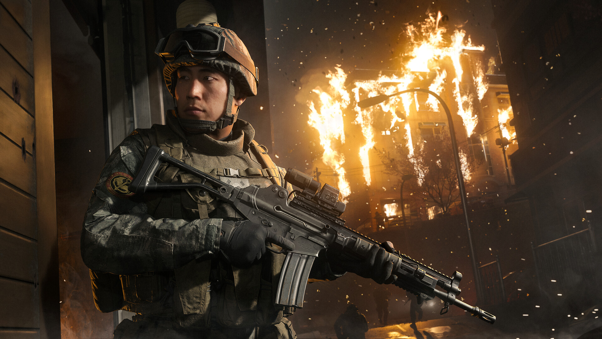 A soldier in combat gear aims a rifle in front of a burning building in Call of Duty: Modern Warfare 4