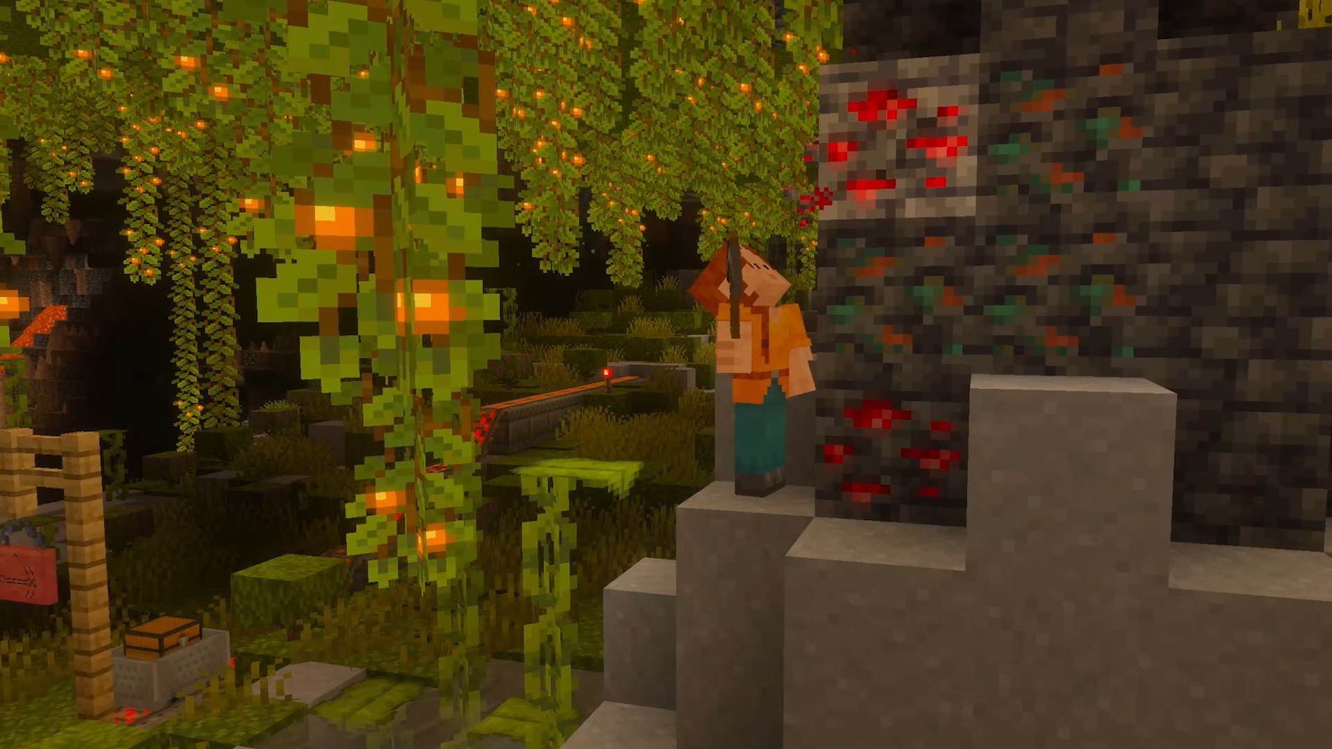 Minecraft for Nintendo Switch 2 screenshot of a player in a lush cave lit by glow berries next to redstone ore