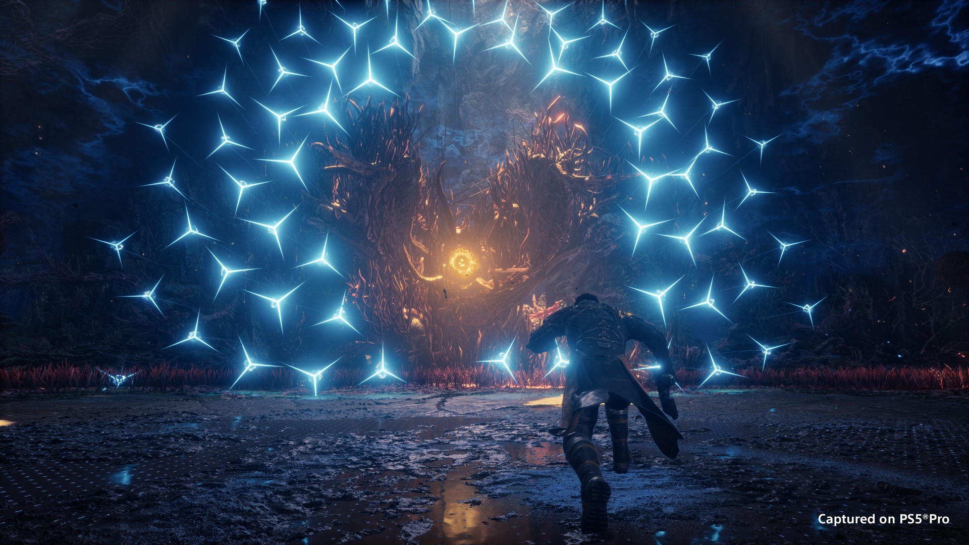 Arjun races through a ring of blue star-shaped projectiles toward a glowing orange core in Saros
