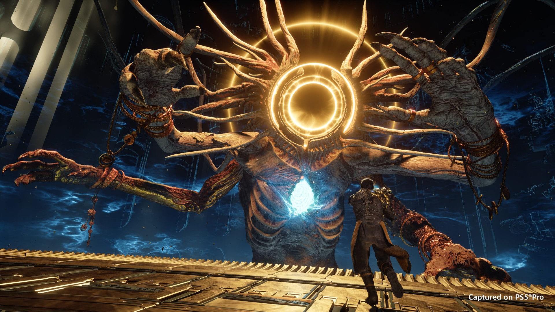 Arjun faces a massive multi-limbed boss with a glowing golden ring for a head in Saros
